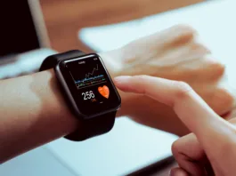 Close up of hand touching smartwatch with health app on the screen, gadget for fitness active lifestyle.