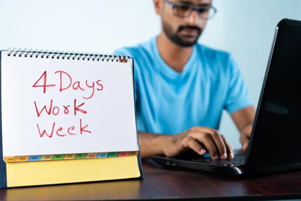 focus on calendar, Concept of four or 4 days work week showing by young man working in background and shows calendar