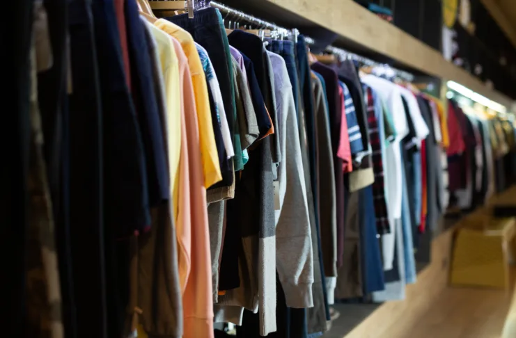 Male clothes on hangers in apparel boutique