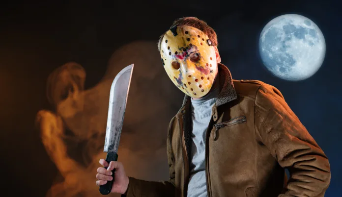 man in maniac movie hockey mask and machete in halloween costume on friday