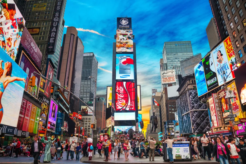 NEW YORK CITY - MAY 11: Times Square with tourists on May 11, 2013. Iconified as The Crossroads of the World it's the brightly illuminated hub of the Broadway Theater District.953