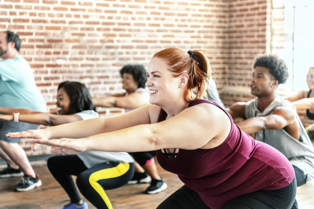 People doing squats in fitness class