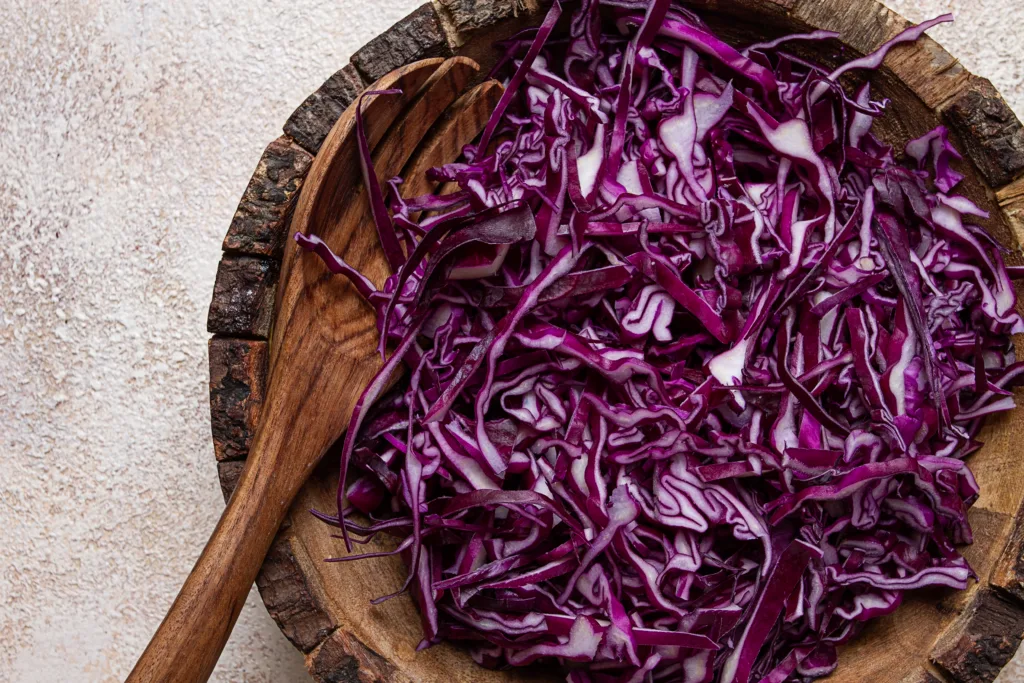 red cabbage, sliced, in a wooden salad bowl, top view, no people,