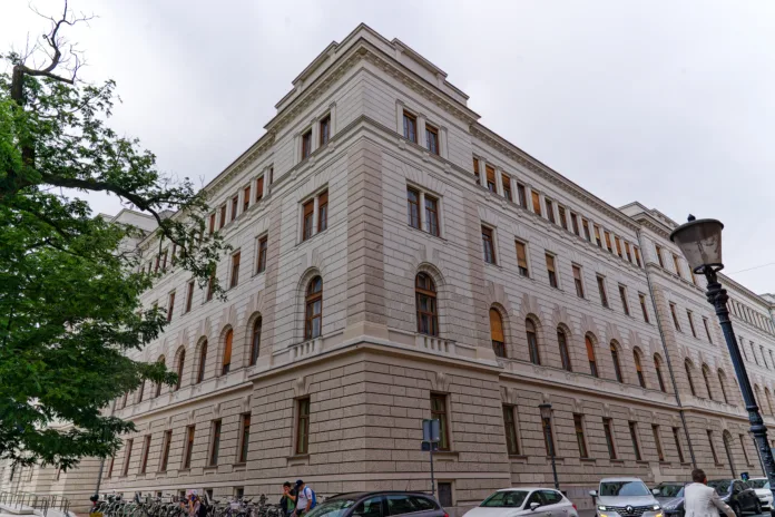 Sightseeing at City of Ljubljana with facade of white large court building on a cloudy summer day. Photo taken August 9th, 2023, Ljubljana, Slovenia.