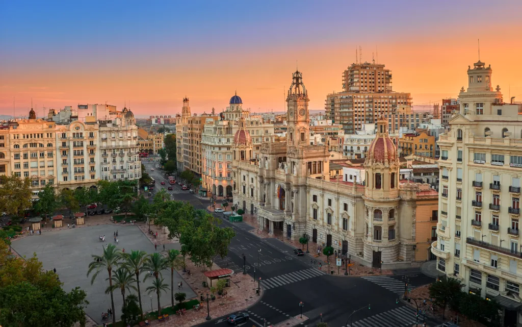 Valencia, Spain, August 19, 2018. Aerial view of the old Town Hall and its square, North Station and other historic buildings in the area, at sunset.