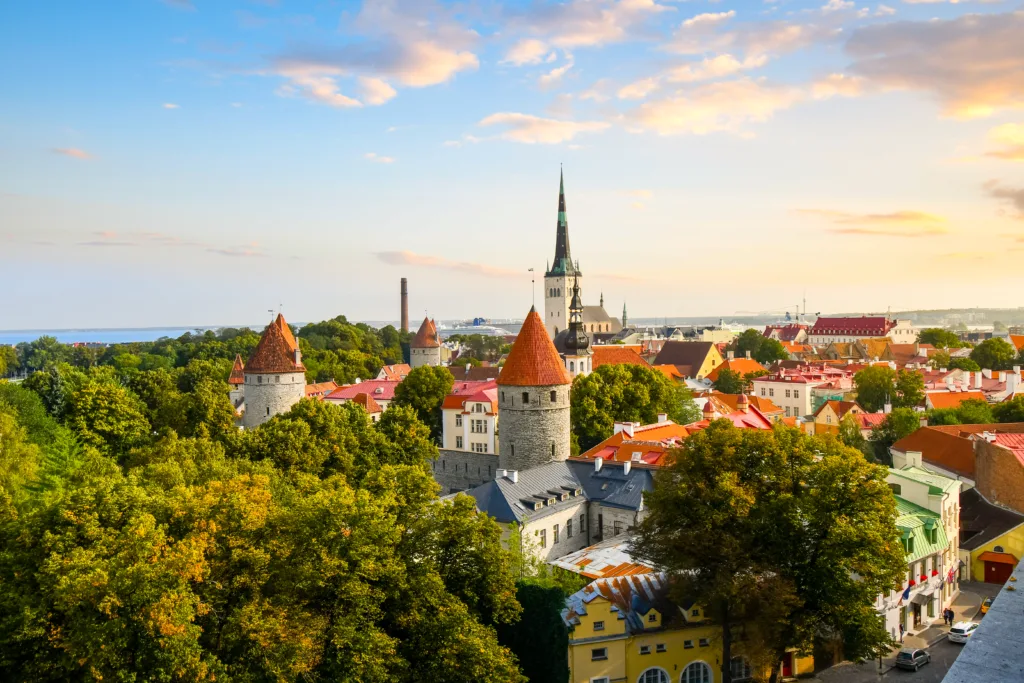 View of the medieval walled city of Tallinn Estonia as the sun sets from above the city at Toompea Hill.