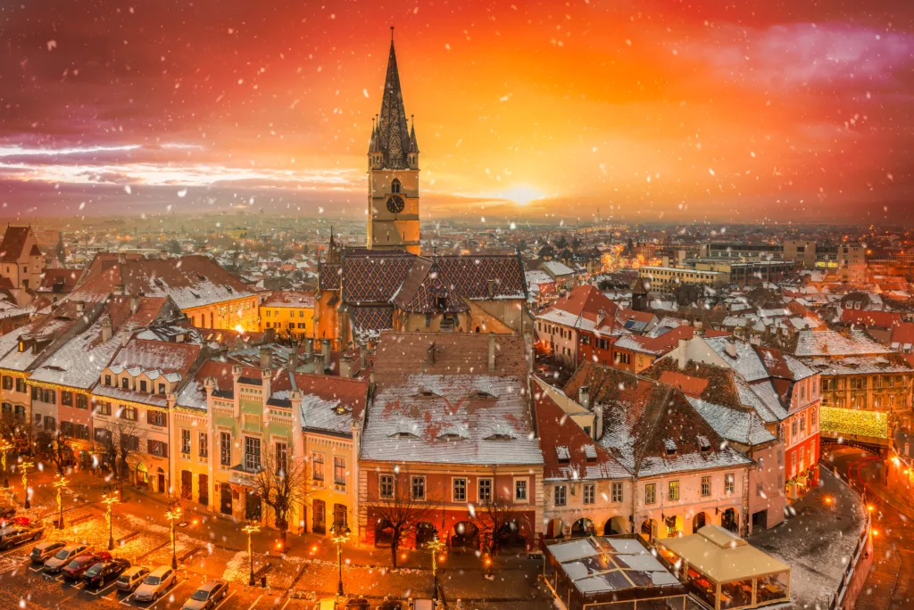 Winter atmosphere in Sibiu, Romania. Discover a winter wonderland of snow-covered medieval architecture, twinkling lights, and festive charm in this historic Transylvanian city.