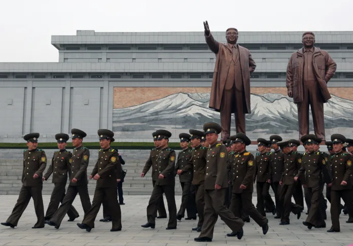 April 13, 2018. Mansudae Grand Monument, Pyongyang, North Korea.Soldiers visiting the huge statues of North Korean leaders. Kim Il-Sung and Kim Jong-Il have special posters and monuments in different parts of the city. The most important of these monuments is the giant sculptures of North Korea's founding leader Kim Il-Sung and his son Kim Jong-Il. All tourists who come to visit the country have to come here and show their respects.