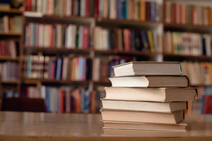 Close up of books on desk in library.