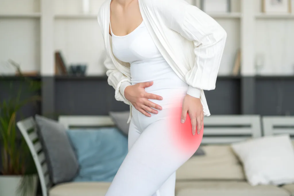 Hip pain, woman suffering from osteoarthritis at home, health problems concept