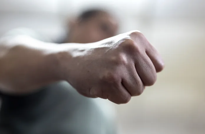 The angry man clenched his fist. Concept of violence.