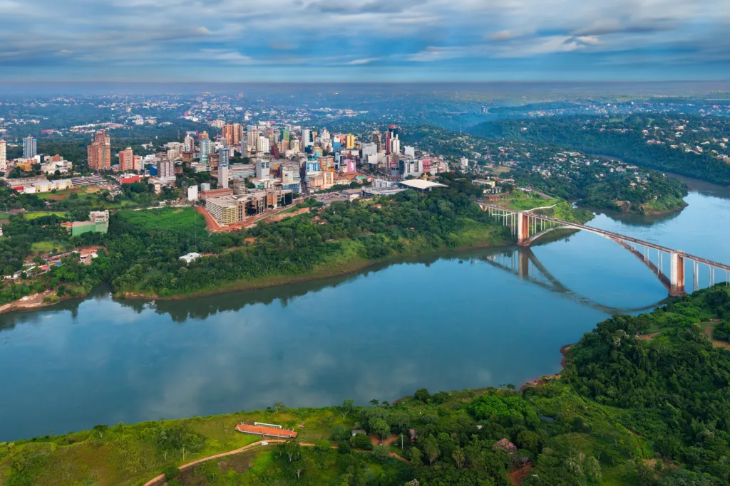 Aerial view of the Paraguayan city of Ciudad del Este and Friendship Bridge, connecting Paraguay and Brazil through the border over the Parana River,.