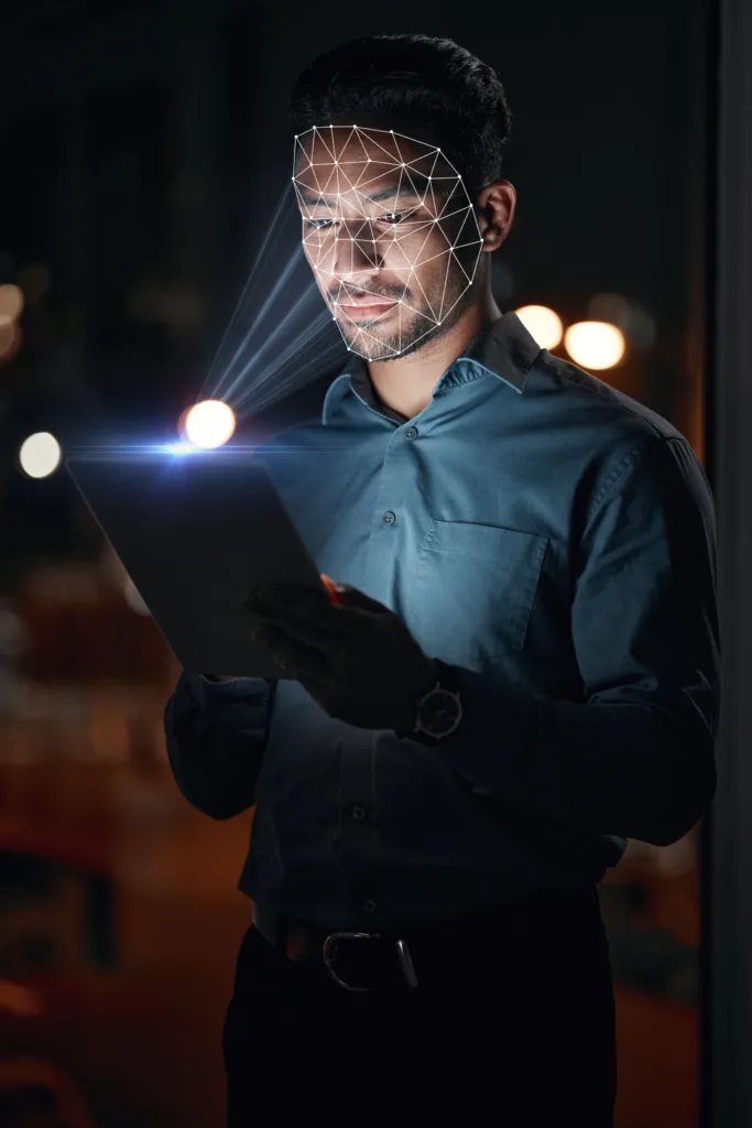 Asian man, tablet and facial recognition at night in biometrics for access, verification or identification at office. Businessman working late with technology and scanning face for cyber security