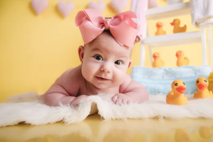 baby girl posing and smiling bathing