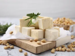 Delicious tofu cheese, rosemary and soybeans on light gray textured table, closeup