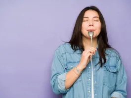 Gorgeous caucasian woman in her 30s eating delicious food with a spoon and enjoying dessert