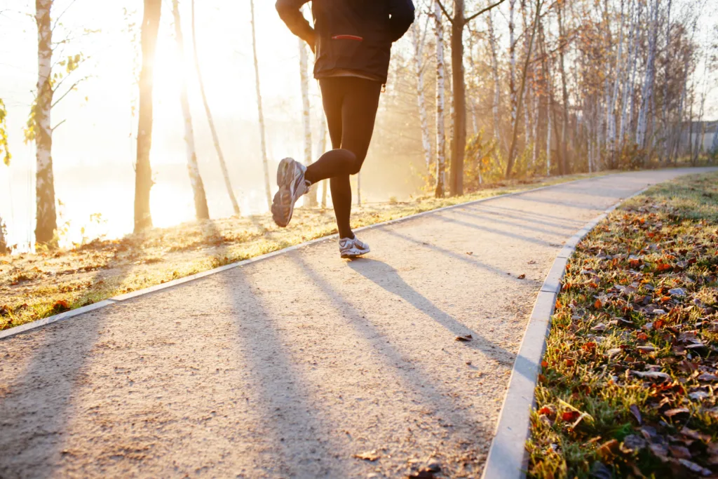 Man running at autumn during sunrise