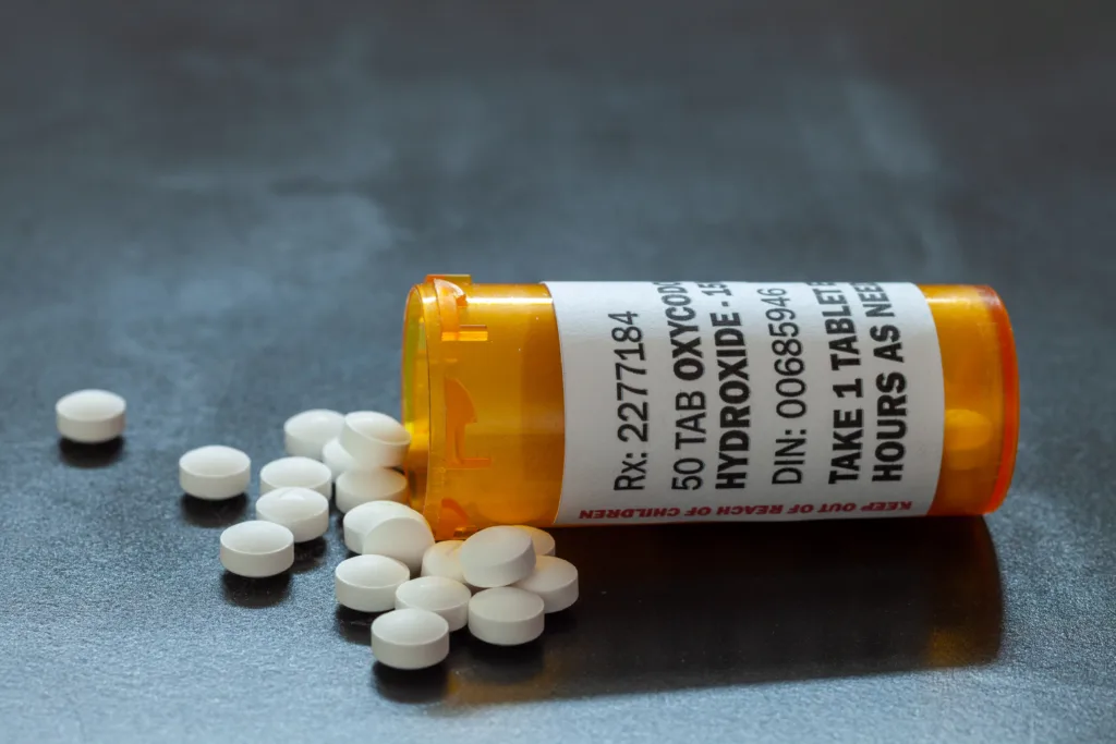 Prescription bottle with backlit Oxycodone tablets. Oxycodone is a generic prescription opioid. A concept of the opioid epidemic crisis