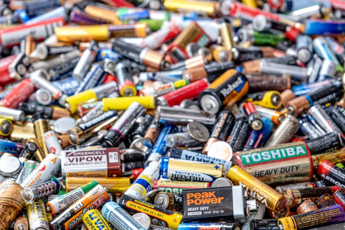 Sibiu, Romania - December 01, 2021. Used batteries from different manufacturers, waste, collection and recycling, high danger for the environment. Batteries background