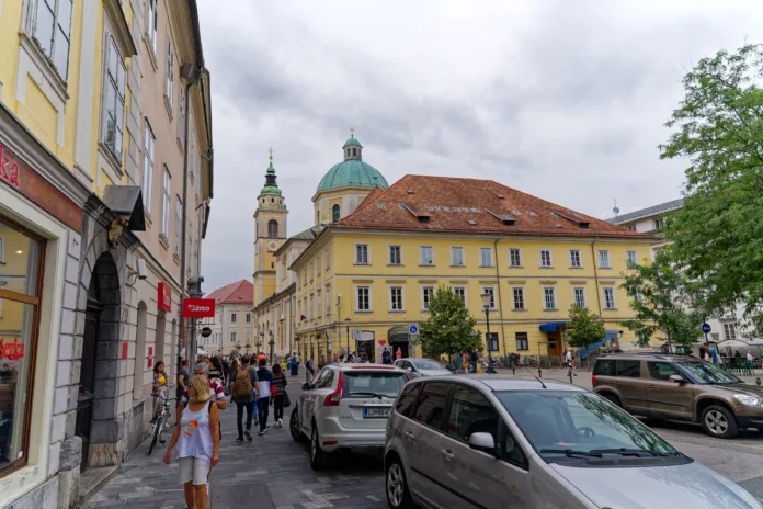 Sightseeing at the old town of City of Ljubljana with cathedral in the background and Vodnik Square in the foreground on a cloudy summer day. Photo taken August 9th, 2023, Ljubljana, Slovenia.