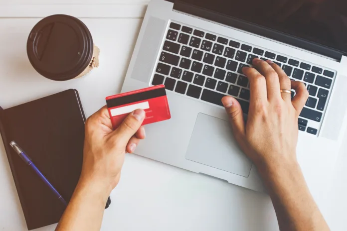 Top view of man using credit card for online shoping