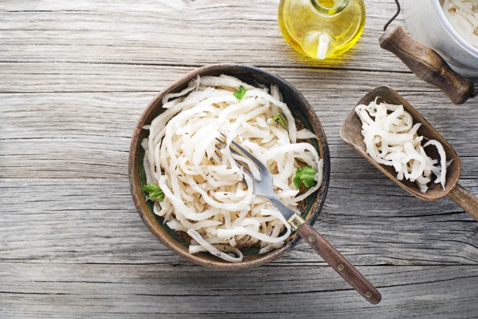 Traditional fresh and healthy sour turnip in bowl on wooden background