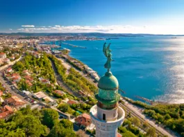 Trieste lighthouse Phare de la Victoire and cityscape panoramic aerial view, Friuli Venezia Giulia region of Italy